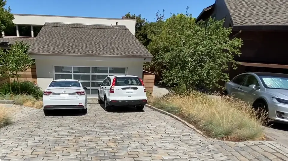 Interlocking paver driveway in front of a single-story home